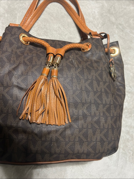 Michael Kors Handbags - Michael Kors Brown MK Monogram Drawstring Tassel Shoulder Bag